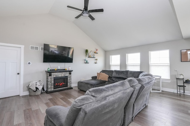 living area with visible vents, baseboards, ceiling fan, and wood finished floors