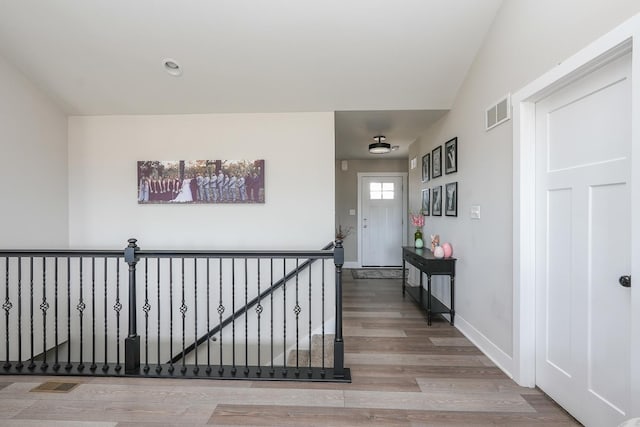 interior space with visible vents, baseboards, and wood finished floors