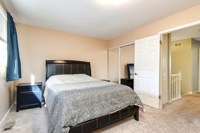 bedroom featuring visible vents, baseboards, carpet, and a closet