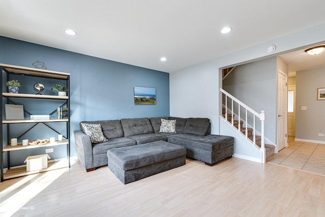 living room featuring recessed lighting, stairs, baseboards, and wood finished floors