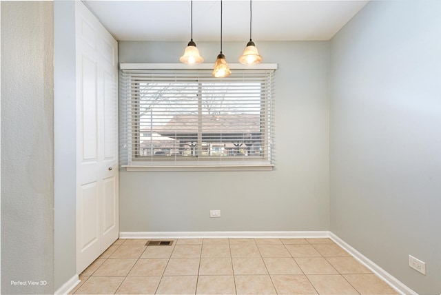 unfurnished room featuring visible vents, baseboards, and tile patterned flooring