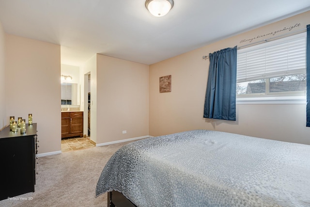 bedroom with baseboards and light colored carpet