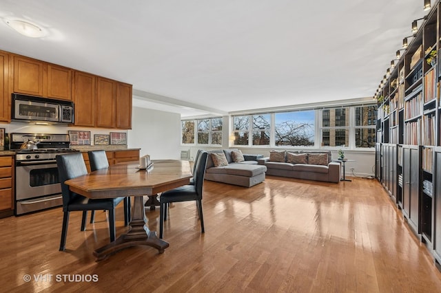 dining space featuring light wood-type flooring