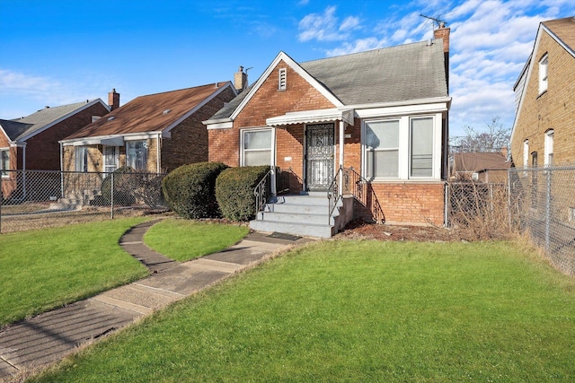 bungalow featuring brick siding, a front yard, and fence