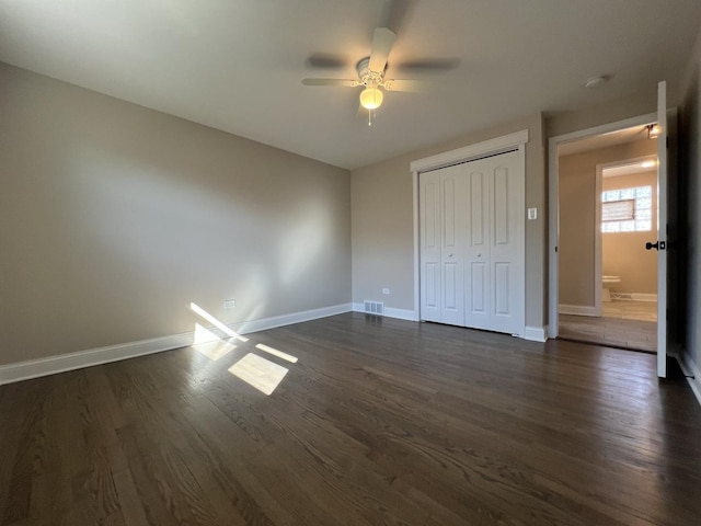 unfurnished bedroom with visible vents, baseboards, a closet, a ceiling fan, and dark wood-style flooring