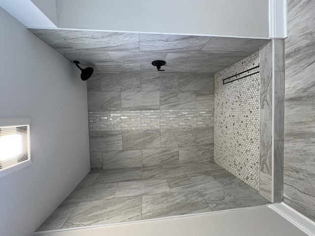 full bath featuring a tile shower