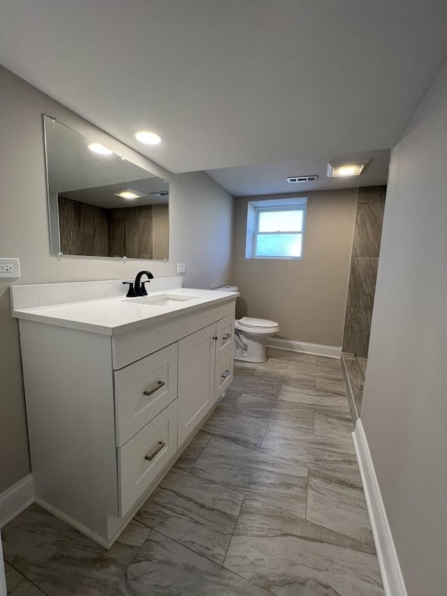 full bath with visible vents, toilet, marble finish floor, baseboards, and vanity