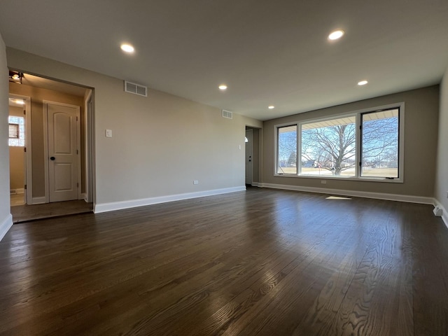 spare room with visible vents, recessed lighting, and dark wood-type flooring