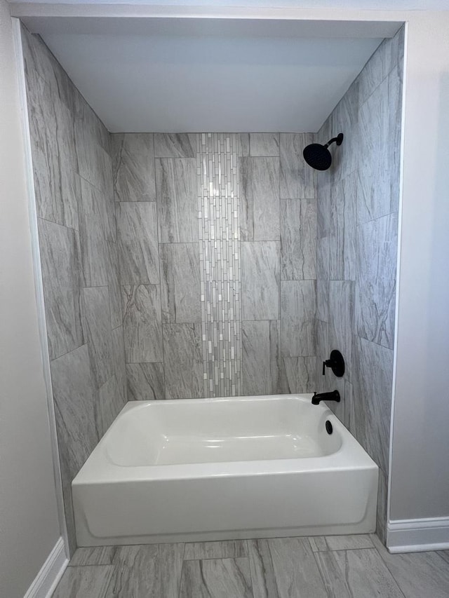 full bathroom featuring tub / shower combination, baseboards, and marble finish floor