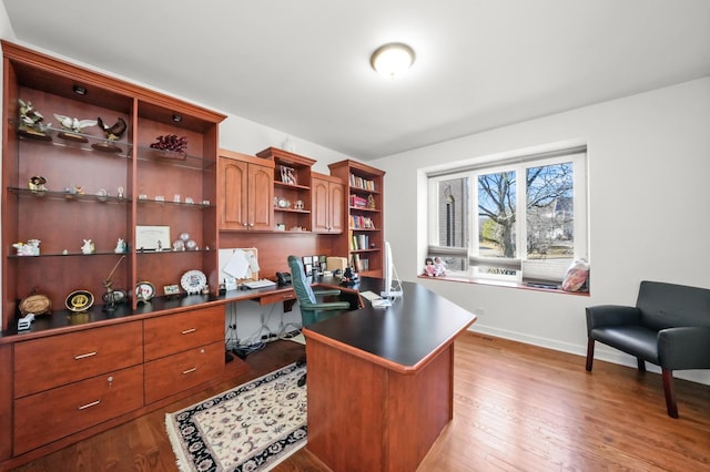 office area with baseboards and light wood-type flooring