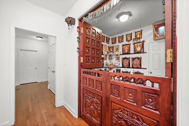 wine area featuring wood finished floors and baseboards