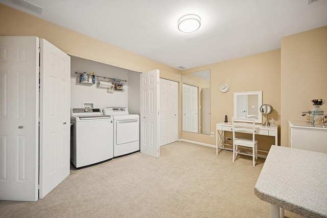 laundry room featuring light colored carpet, separate washer and dryer, visible vents, and laundry area