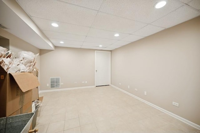 finished basement featuring recessed lighting, visible vents, baseboards, and a drop ceiling