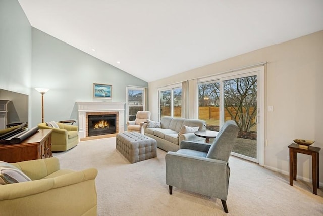 living area featuring baseboards, light colored carpet, a brick fireplace, and high vaulted ceiling