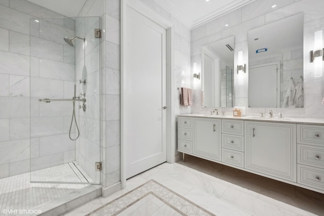 full bath featuring a sink, a shower stall, double vanity, and ornamental molding