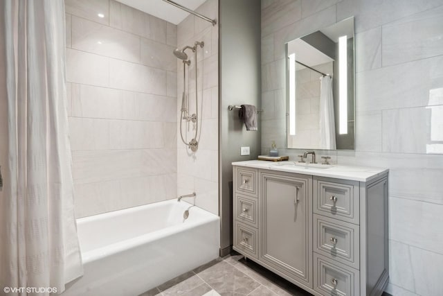 bathroom featuring vanity, tile walls, and shower / bathtub combination with curtain