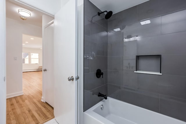 bathroom featuring shower / bathing tub combination, baseboard heating, and wood finished floors