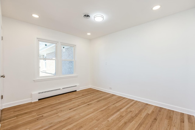 empty room featuring visible vents, recessed lighting, light wood finished floors, baseboards, and baseboard heating