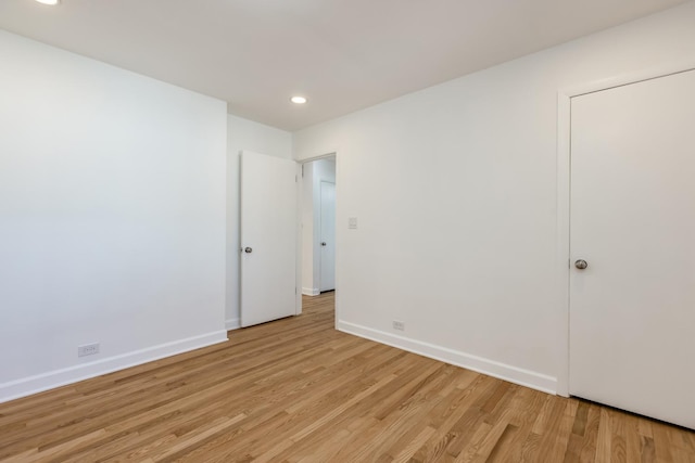 empty room with recessed lighting, baseboards, and light wood finished floors