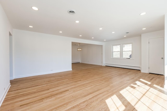 unfurnished room featuring light wood-type flooring, recessed lighting, visible vents, and a baseboard radiator