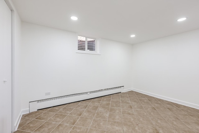 interior space with a baseboard heating unit, recessed lighting, and baseboards