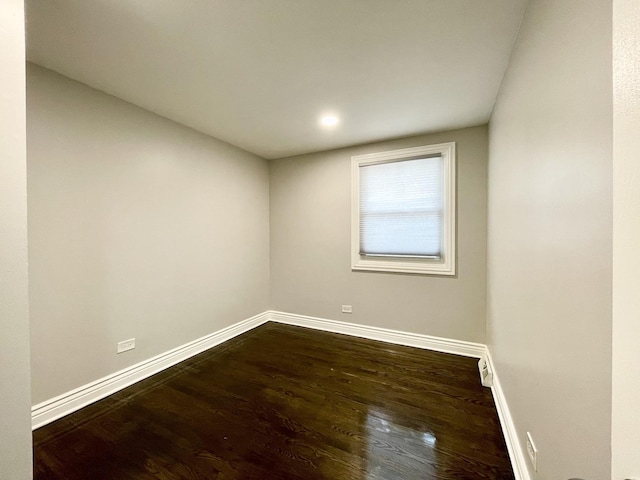 unfurnished room featuring dark wood finished floors and baseboards