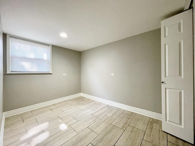 unfurnished room featuring wood finish floors and baseboards