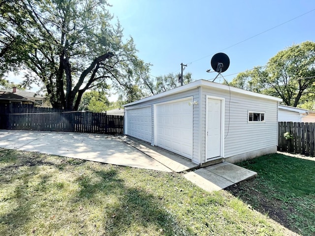 detached garage featuring fence