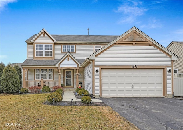 view of front of home with aphalt driveway, fence, covered porch, an attached garage, and a front yard