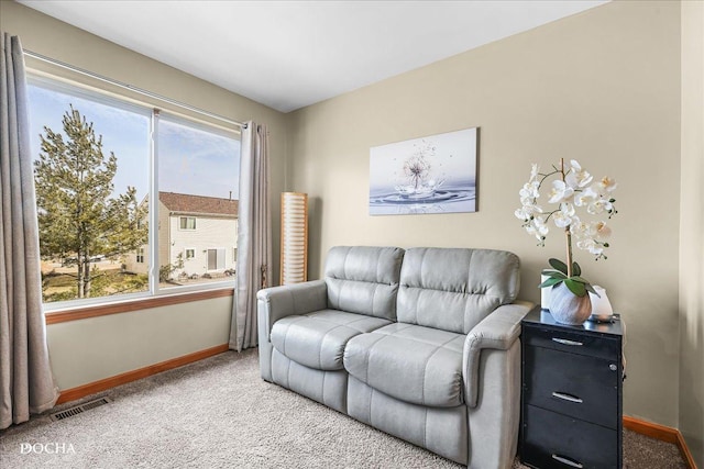 living room with visible vents, baseboards, carpet, and a healthy amount of sunlight