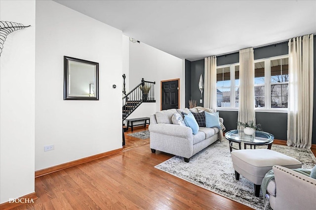 living room with stairway, wood finished floors, and baseboards