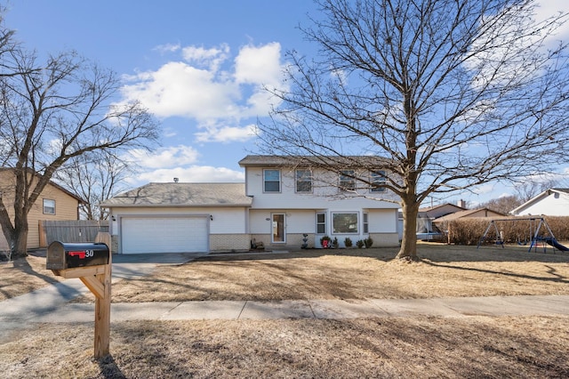 view of front of home with driveway, fence, a playground, a garage, and brick siding