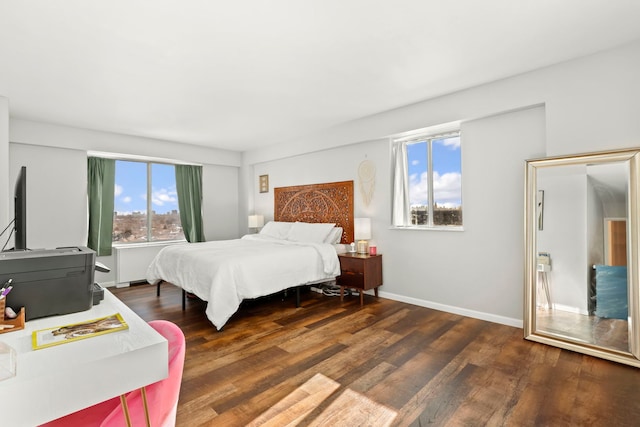 bedroom with wood finished floors and baseboards