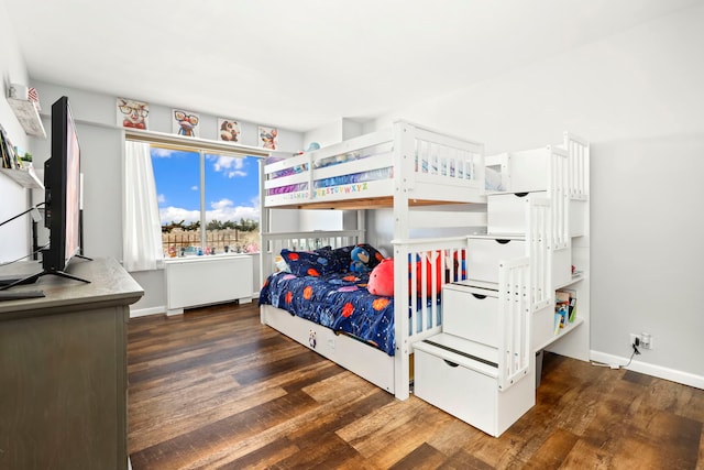 bedroom featuring baseboards and wood finished floors