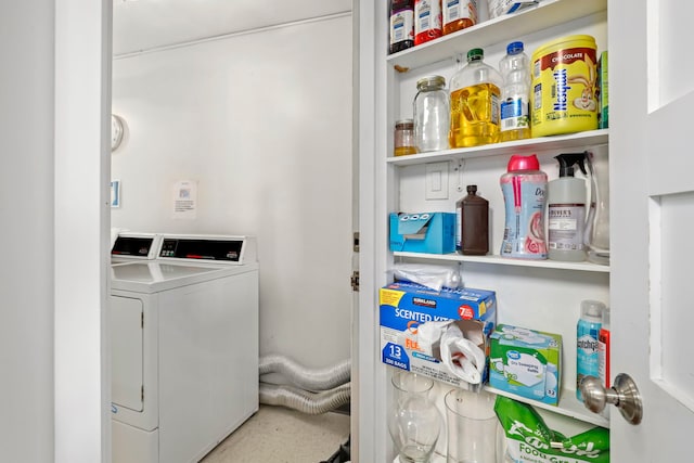 laundry area with washing machine and clothes dryer