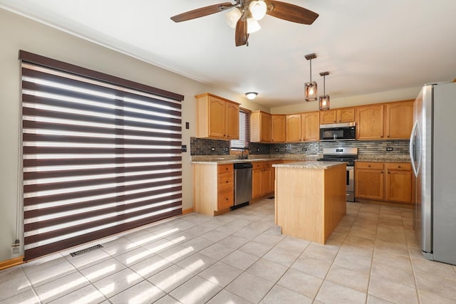 kitchen featuring tasteful backsplash, visible vents, appliances with stainless steel finishes, and a kitchen island