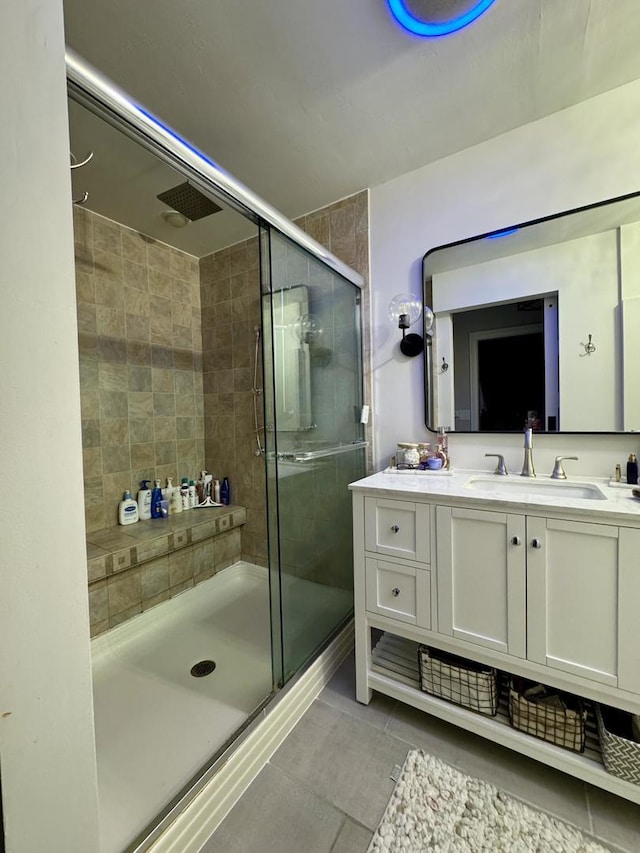 bathroom featuring vanity, tile patterned floors, and a stall shower