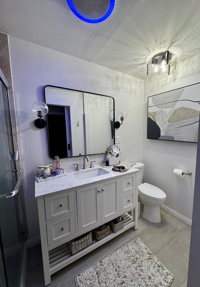 bathroom with baseboards, toilet, and vanity