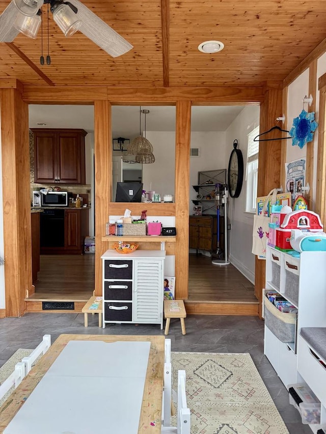 interior space featuring visible vents, wooden ceiling, baseboards, and ceiling fan