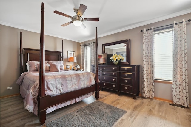 bedroom with baseboards, wood finished floors, a ceiling fan, and ornamental molding