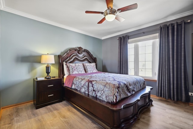 bedroom featuring light wood-type flooring, baseboards, and crown molding