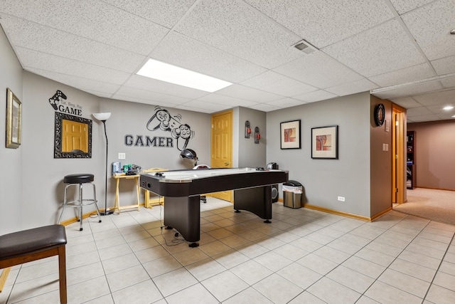 rec room with visible vents, light tile patterned flooring, a paneled ceiling, and baseboards