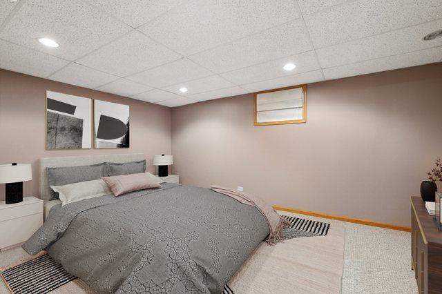 bedroom featuring recessed lighting, a paneled ceiling, and baseboards