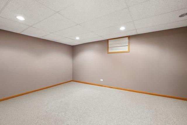 finished basement featuring recessed lighting, baseboards, and carpet flooring