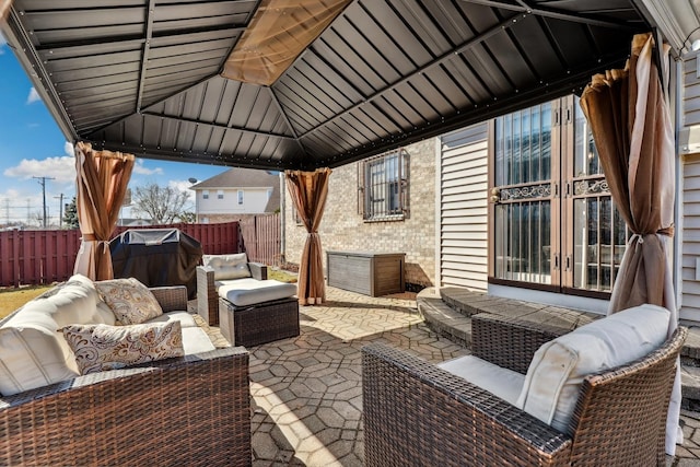 view of patio / terrace featuring a gazebo, outdoor lounge area, and fence