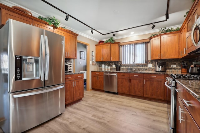 kitchen with stainless steel appliances, brown cabinets, backsplash, and ornamental molding