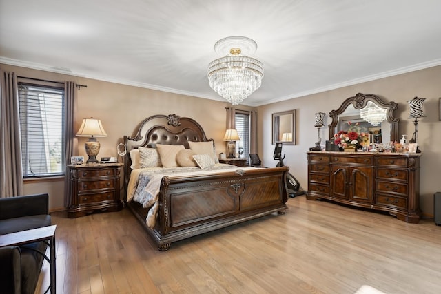 bedroom featuring a chandelier, light wood-style flooring, and crown molding