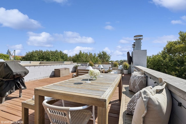 deck featuring outdoor dining space and a grill