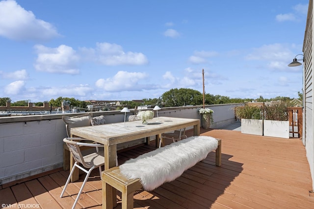 wooden deck featuring outdoor dining space