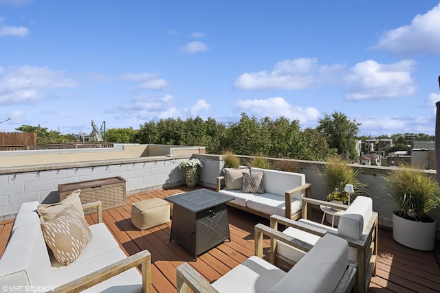 wooden deck with an outdoor living space with a fire pit